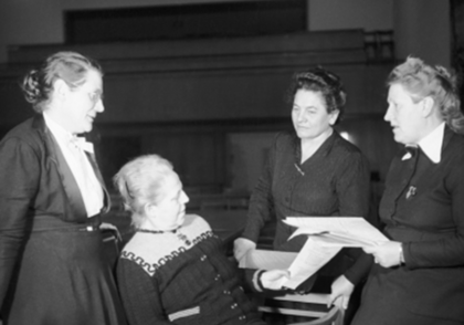 Schwarz-Weiß-Foto: Vier Damen unterhalten sich miteinander